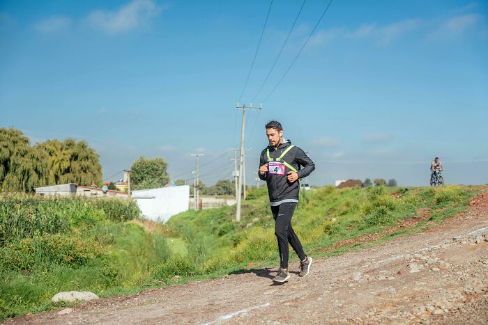 Man running on a dirt path outdoors, experiencing a moment related to trying something once and developing a strong dislike.