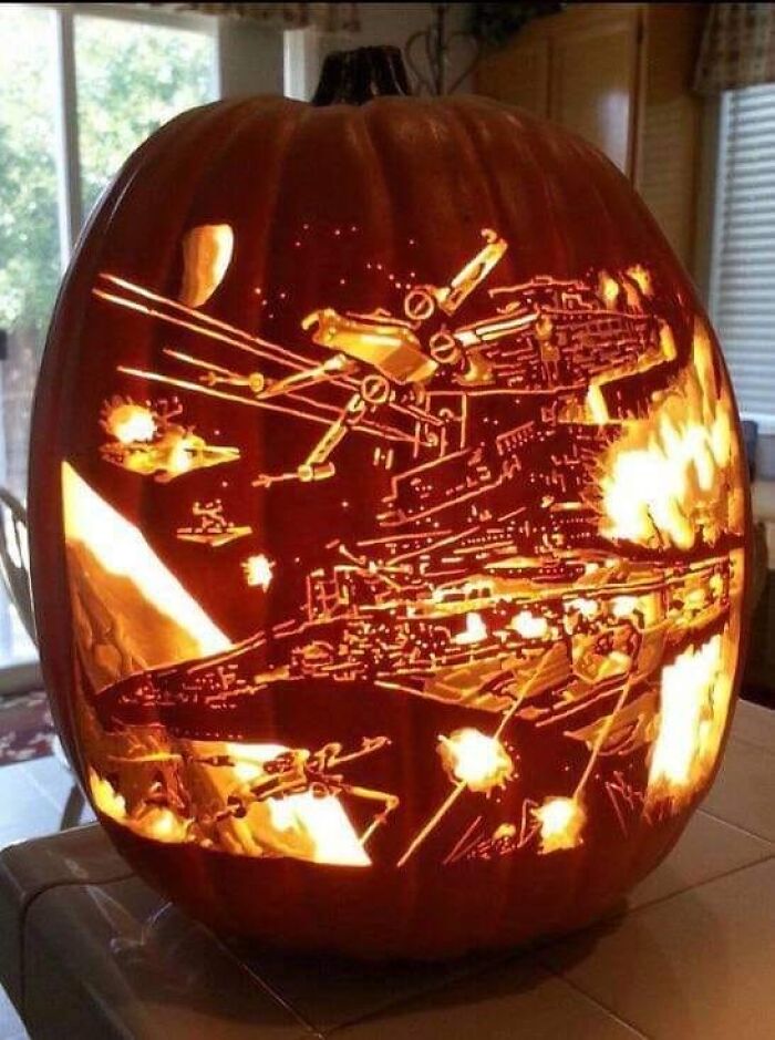 Intricately carved pumpkin showcasing a space battle scene, a spooky and jaw-droppingly charming pumpkin carving design.