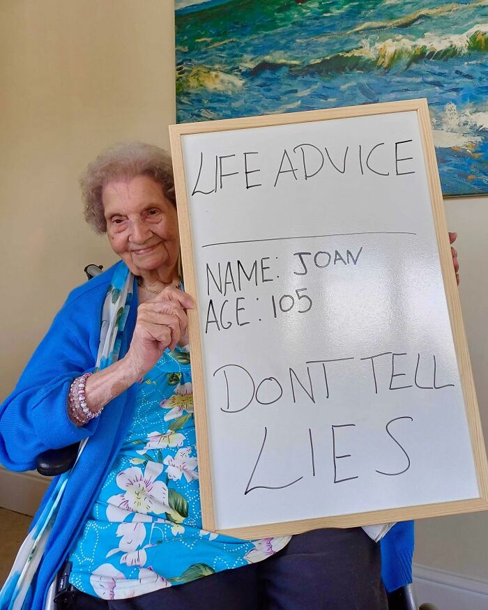 Elderly woman giving life advice on a whiteboard, part of elders doling out life advice Instagram page.