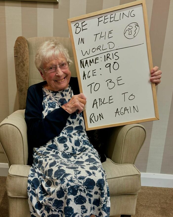 Elderly woman holding a whiteboard with life advice, featured on a page dedicated to elders sharing hard truths.