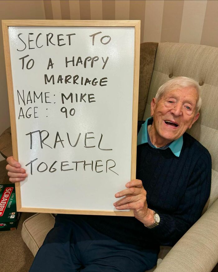 Elderly man sharing life advice on a whiteboard about happy marriage and travel together for elders life advice.