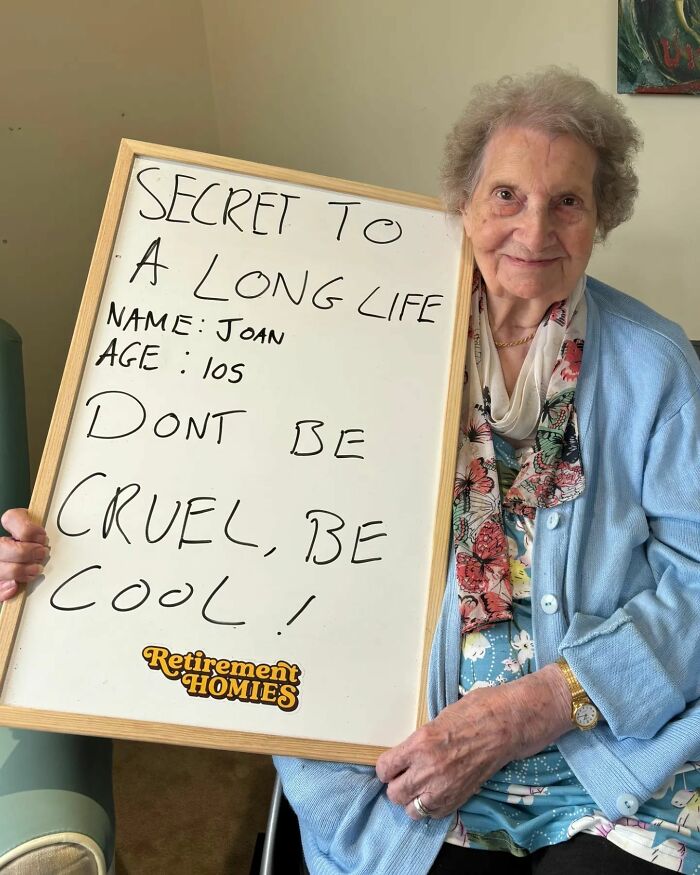 Elderly woman sharing life advice on a whiteboard for an Instagram page dedicated to elders giving life advice.