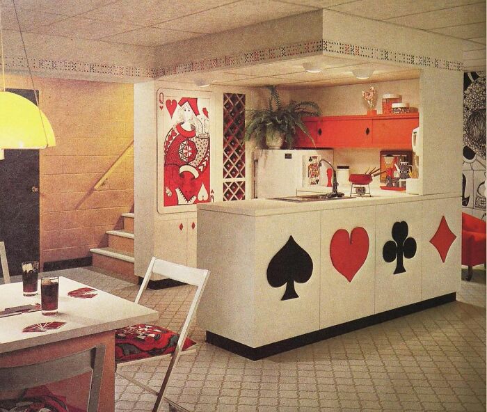 Vintage kitchen interior from the 50s to 80s featuring playing card motifs and retro decor elements.