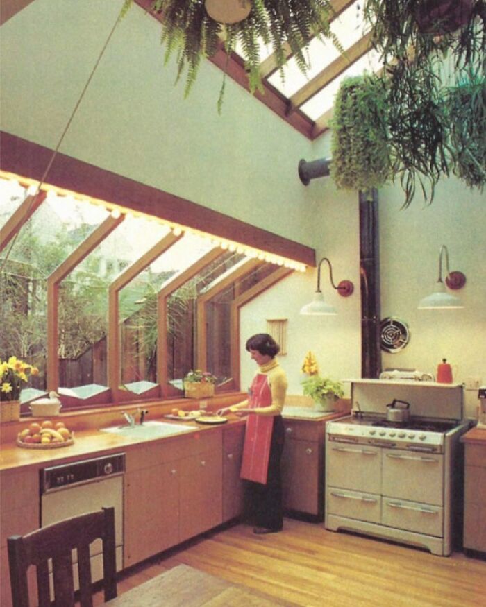 Woman preparing food in a vintage kitchen showcasing captivating interiors from the 50s to 80s with natural light and plants.