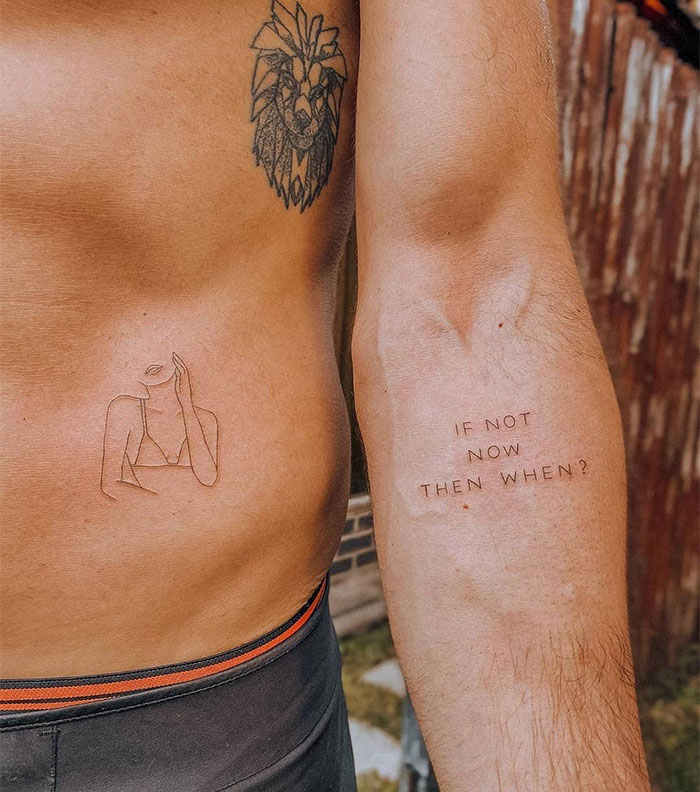 Small tattoos with a lion design and minimalist line art on a man's torso and arm.