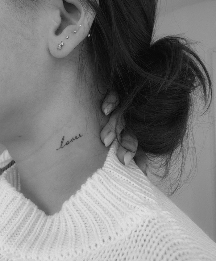 Small tattoo on neck reading "lover" in elegant script, highlighting delicate tattoo ideas.