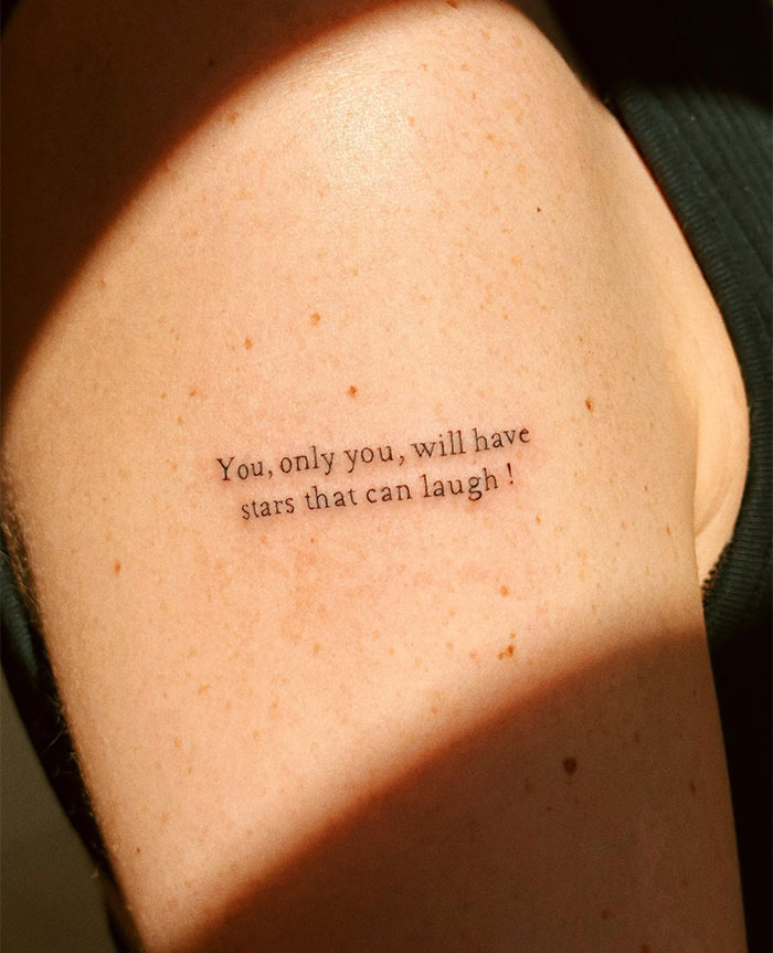Small tattoo on arm with the text "You, only you, will have stars that can laugh," showcasing minimalist tattoo design.