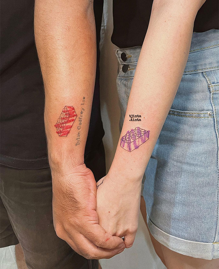 Two arms with small colorful Lego tattoos, symbolizing creative small tattoo ideas.