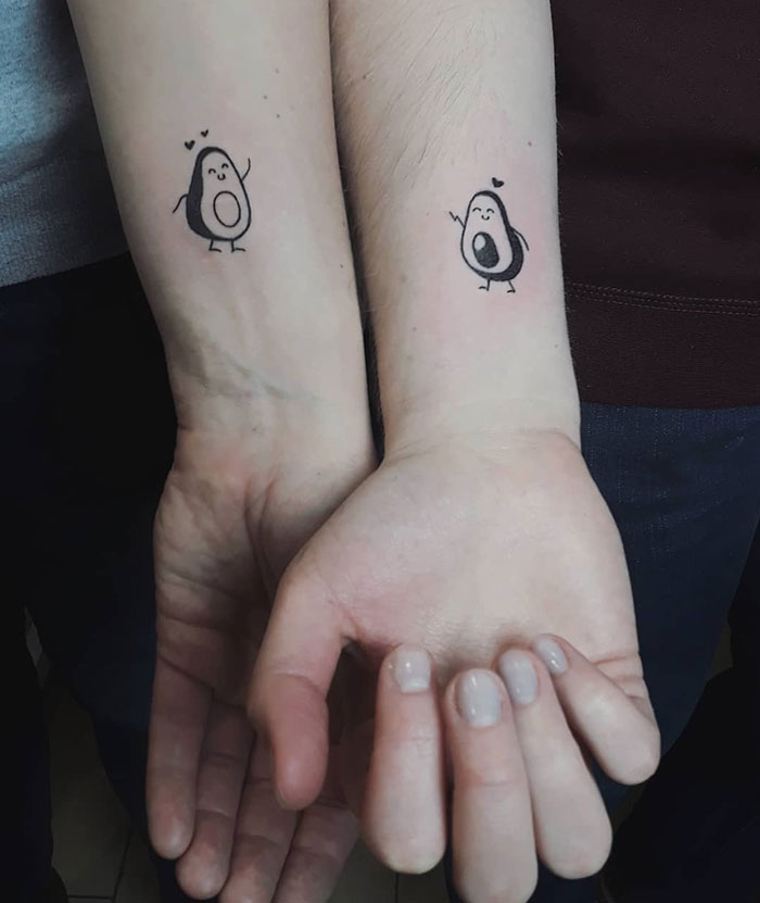Small tattoos of cute avocados on wrists, ideal for those seeking subtle yet impactful body art.