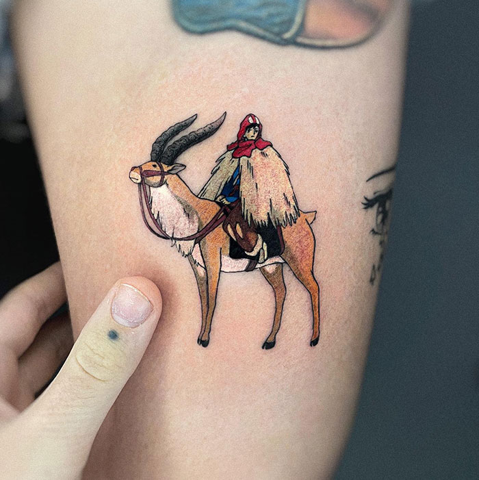 Small tattoo of a rider on a gazelle, showcasing intricate detail and vibrant colors.