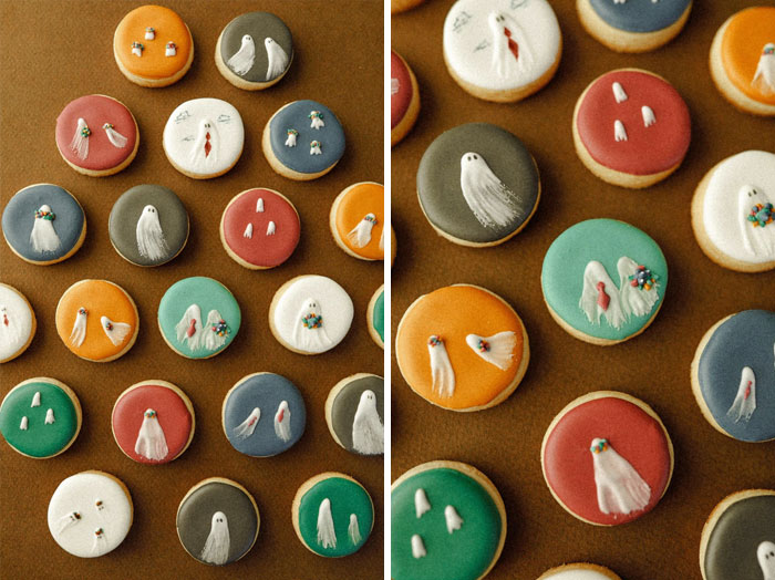 Halloween snacks featuring decorated cookies with colorful icing and ghost designs on a brown background.