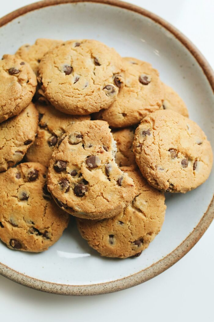 Plate of chocolate chip cookies with one bitten, illustrating people learning of their hatred after trying it once.