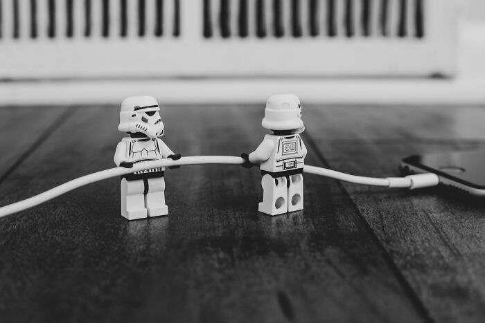 Two Lego Stormtroopers holding a cable on a wooden floor illustrating mind-blowing coincidences.