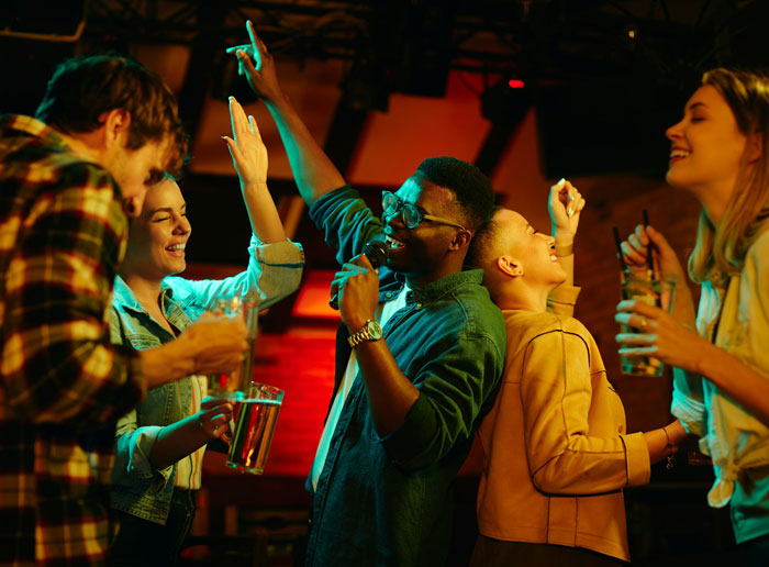 Young adults enjoying a lively night out, highlighting family friend drama and personal choices.