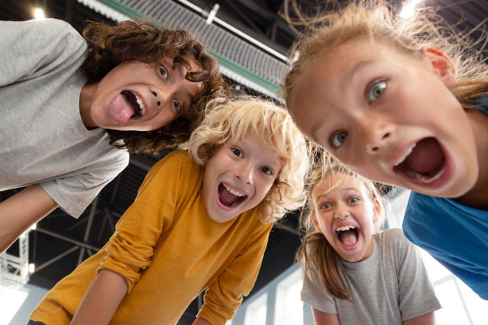 Children looking down at the camera, smiling and excited, indoors. Children looking down at the camera, smiling and excited, indoors.