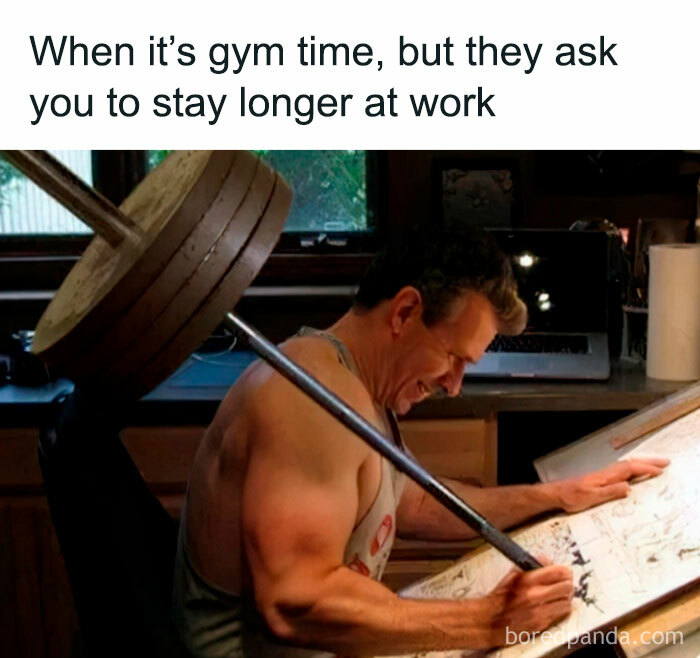 Man struggles with weights while working at desk, illustrating funny gym meme about the agony of ‘just one more rep’.