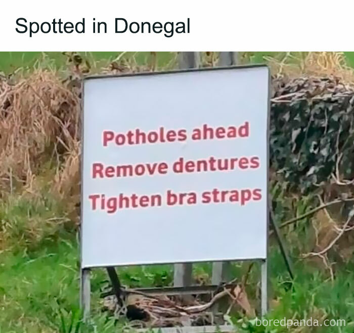 Funny sign in Donegal warns drivers of potholes, humorously advising to remove dentures and tighten bra straps.