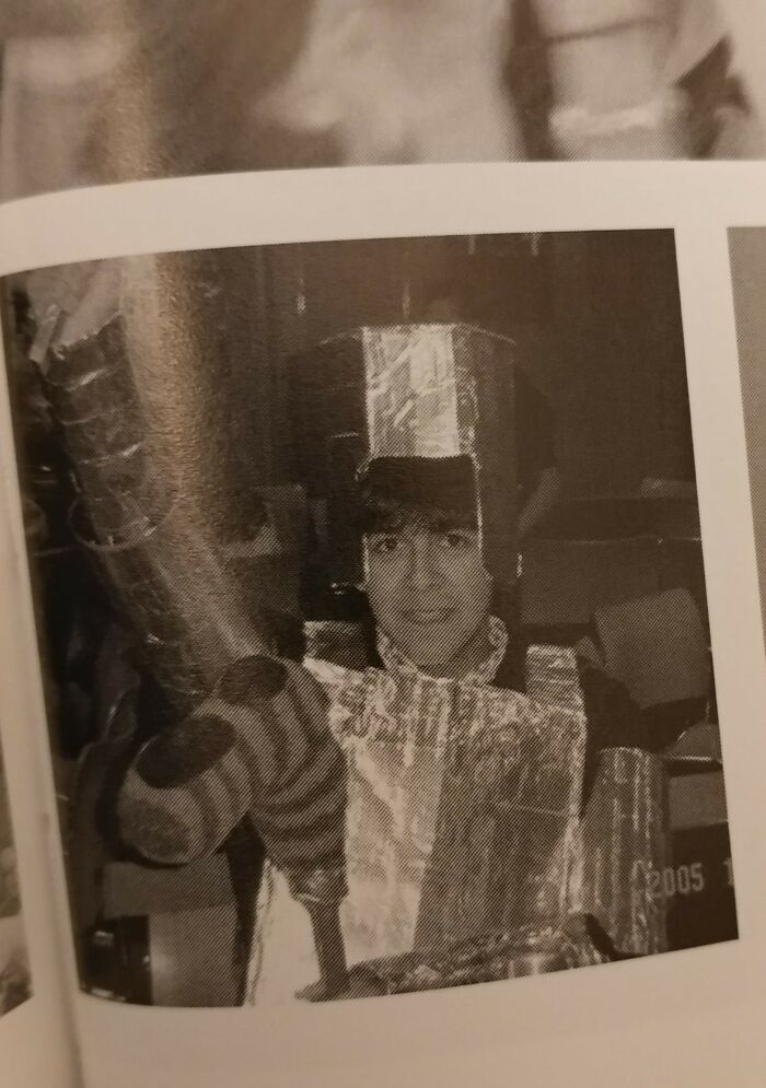 Person in a DIY robot costume made of cardboard and foil, capturing a humorous moment.