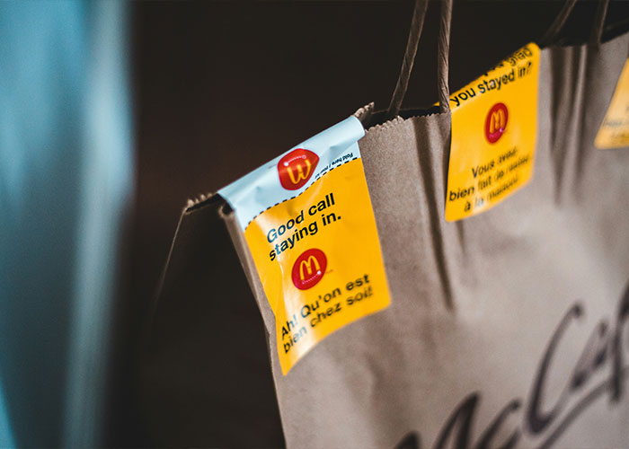 McDonald's takeout bag with stickers, symbolizing petty reasons behind some divorces.