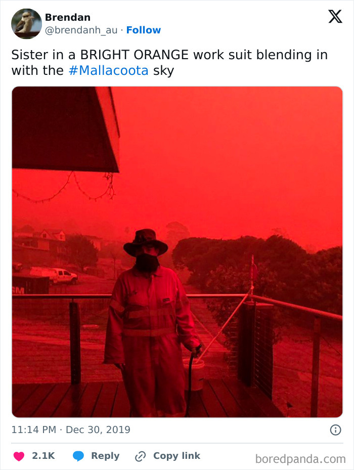 Person in bright orange suit blending with red sky, creating an interesting, not Photoshopped effect in Mallacoota.