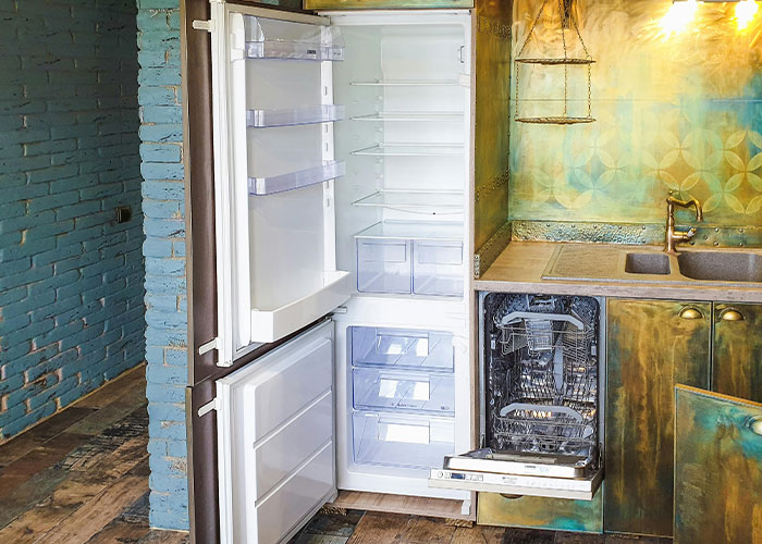Open fridge and dishwasher in a colorful kitchen, highlighting petty reasons for divorce.