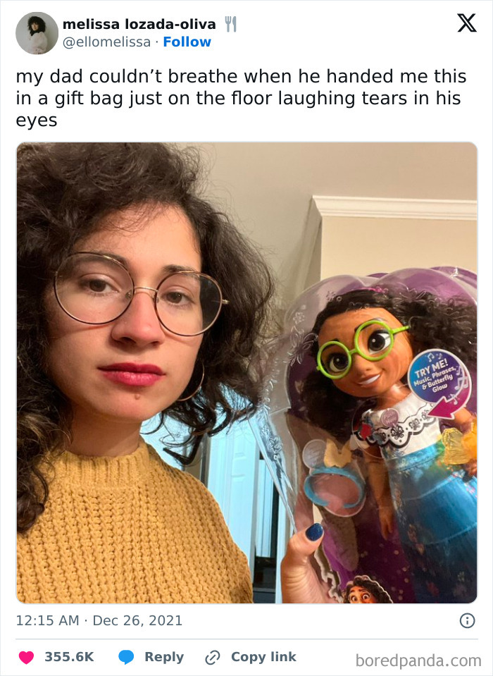 Woman holds doll doppelganger, uncanny resemblance highlights glitch in the matrix.