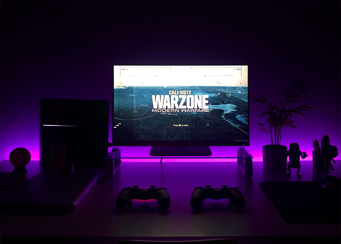 Gaming setup with Call of Duty: Warzone on screen, highlighting petty reasons in divorce themes.