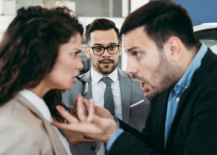 Two men and a woman in a heated argument, capturing a savage insult moment.