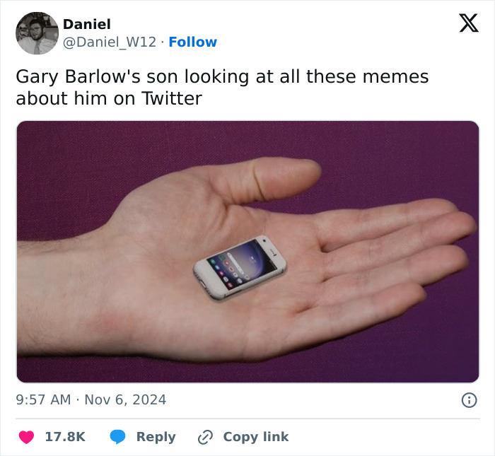 Hand holding a tiny smartphone, symbolizing Gary Barlow's son's towering height sparking memes.