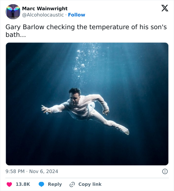 Underwater scene with a man swimming, resembling a humorous meme about Gary Barlow's son and his towering height.