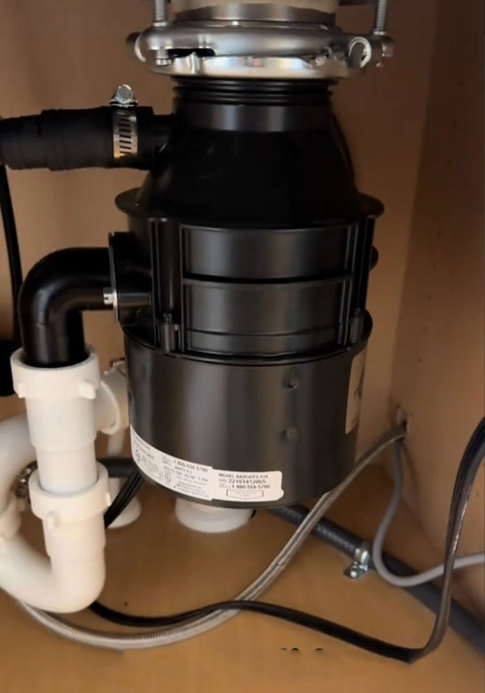 Garbage disposal unit under the sink, part of a $1,600,000 home's surprising condition.