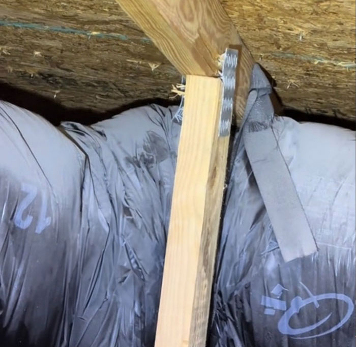 Poor condition of insulation and beam in $1,600,000 home built 2 years ago, highlighting inspection findings.