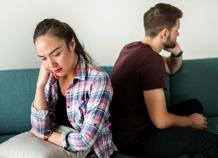 Father supports son; family drama unfolds on a couch, woman upset, man indifferent.