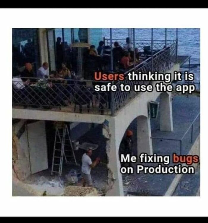 IT meme showing users on a terrace above, unaware of a worker below fixing structural issues, captioned humorously.