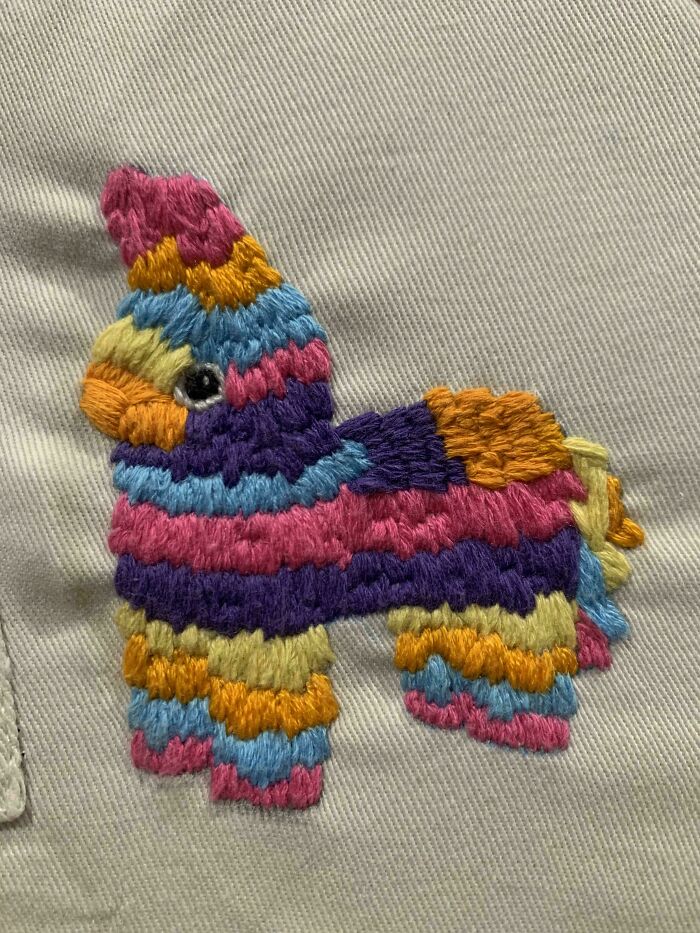 Colorful embroidered piñata design stitched on fabric showcasing beautiful embroidery designs detail and texture.