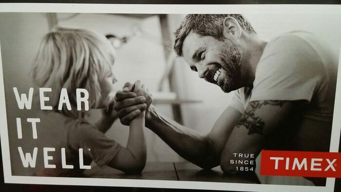Man and child arm wrestling, Timex ad with the phrase "Wear it well", representing funny ad fails.