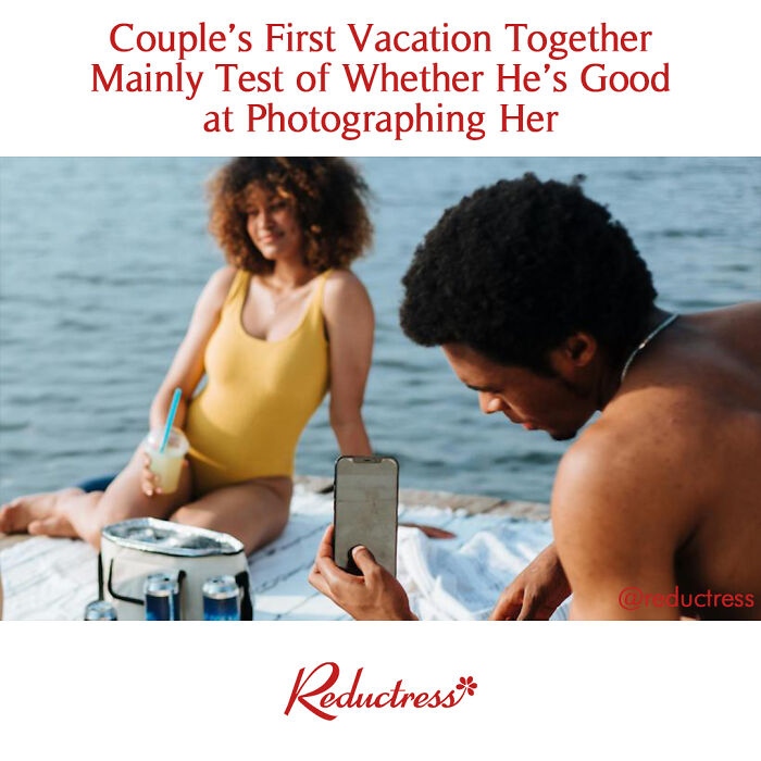 Man photographing woman by water, humorously testing his skills.