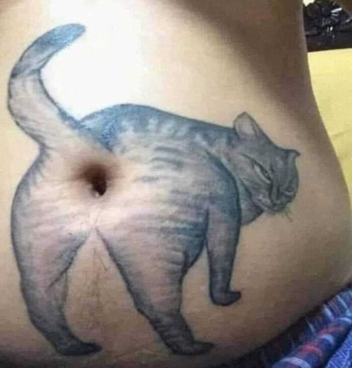 Epic tattoo fail of a cat with its rear end humorously placed around a belly button.