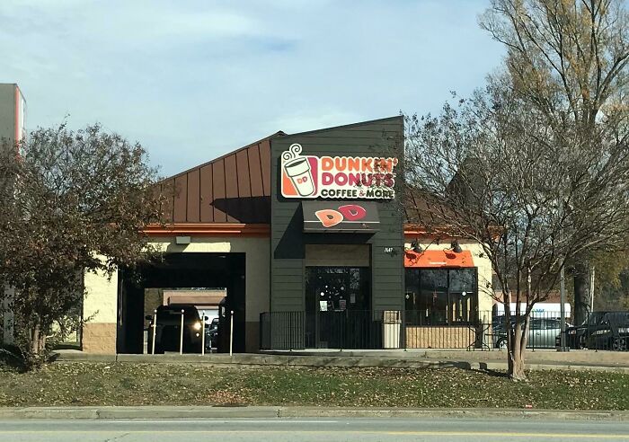 Dunkin' Donuts building conversion with coffee signage, trees, and parking area visible.