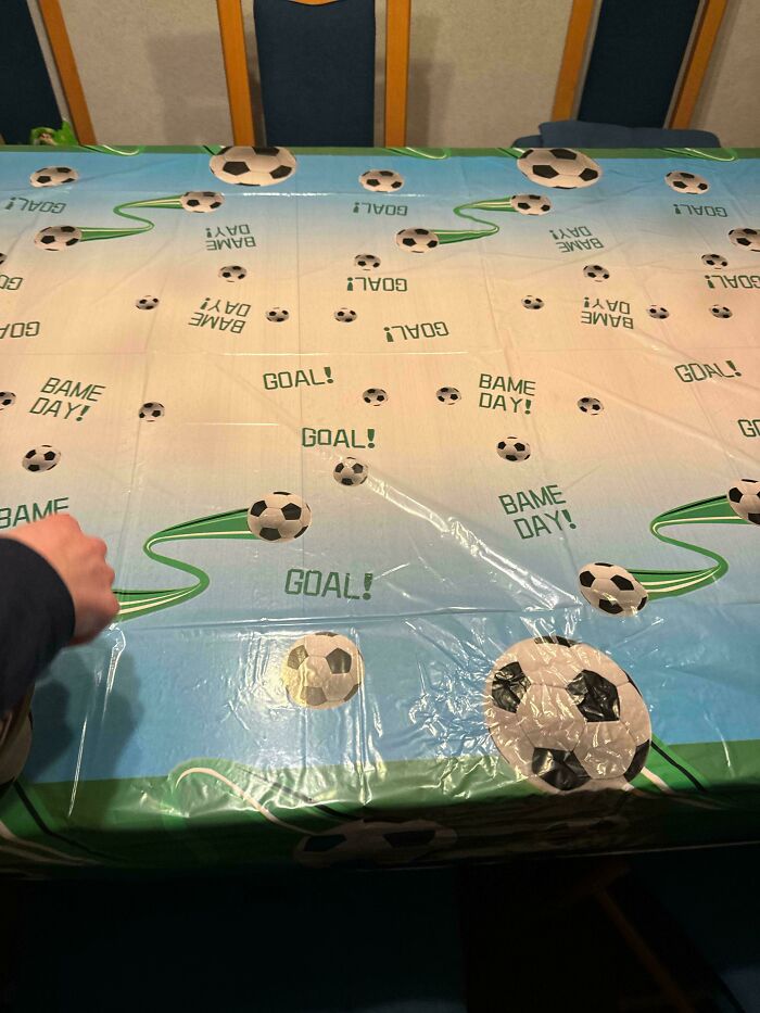 Online shopping fail: a tablecloth with soccer designs and reversed text.