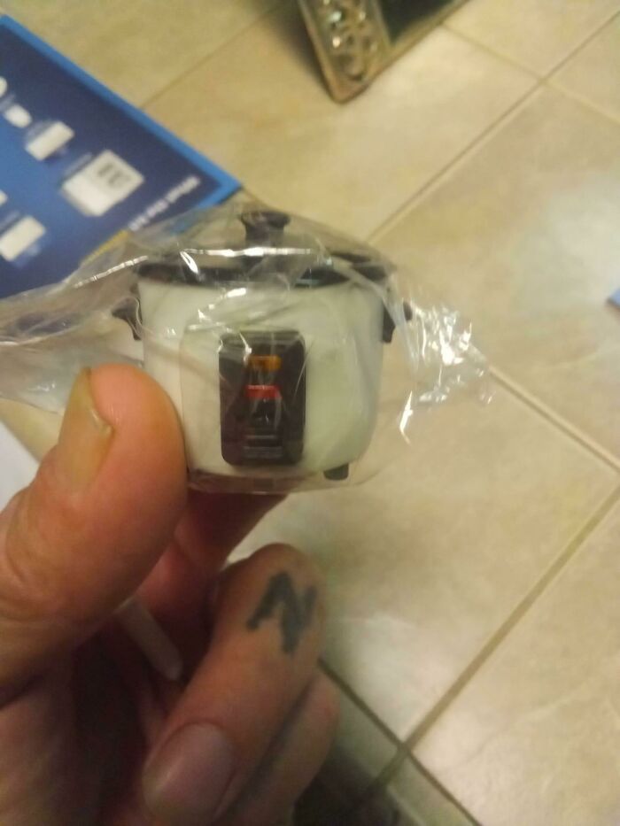 Tiny rice cooker toy in packaging, highlighting an online shopping fail.