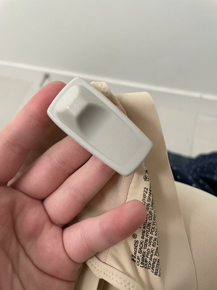 Security tag left on clothing item, highlighting online shopping fails.