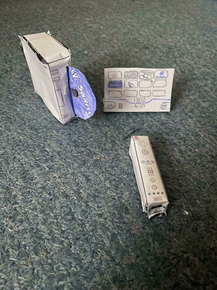 Paper model mimicking a gaming console and remote, highlighting online shopping fails humorously.