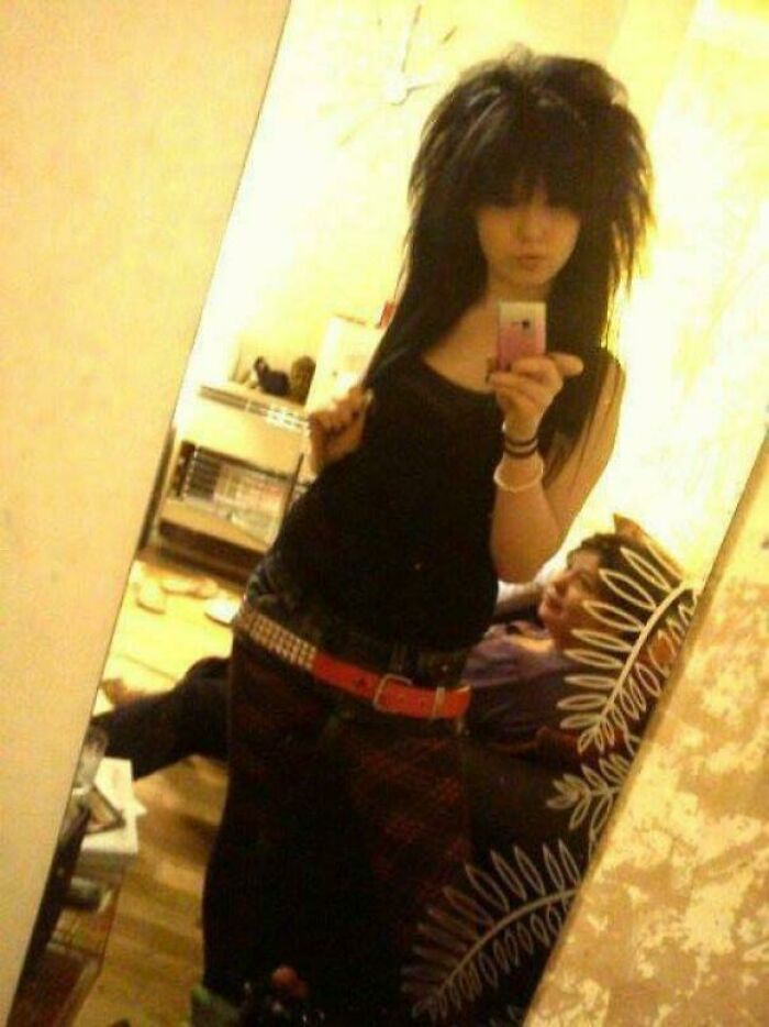 Person in a mirror selfie with an edgy hairstyle, reflecting a fashion choice from their blunder years.