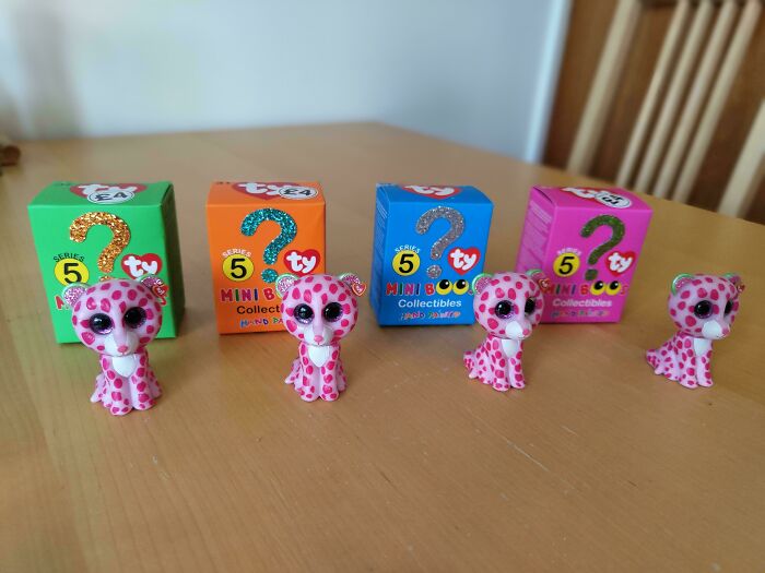 Mini Boo collectibles with polka dot figures, showcasing months of saving regrets on a wooden table.