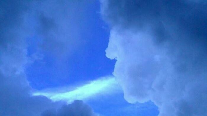 Fascinating cloud shape resembling a face against a vibrant blue sky.