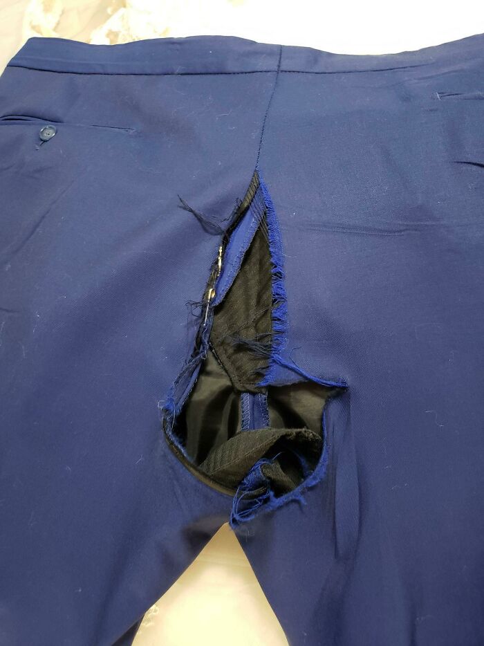 Torn blue pants showing regretful spending after months of saving.