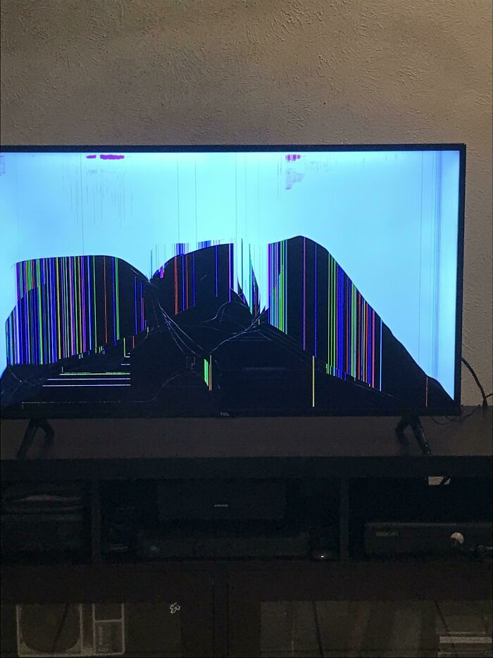 A broken TV screen displaying colorful vertical lines, symbolizing regret over money spent.