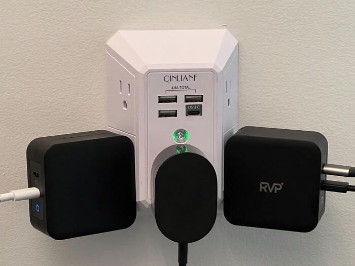 Compact multi-port USB charger plugged into wall outlet with multiple devices connected, popular Amazon find.