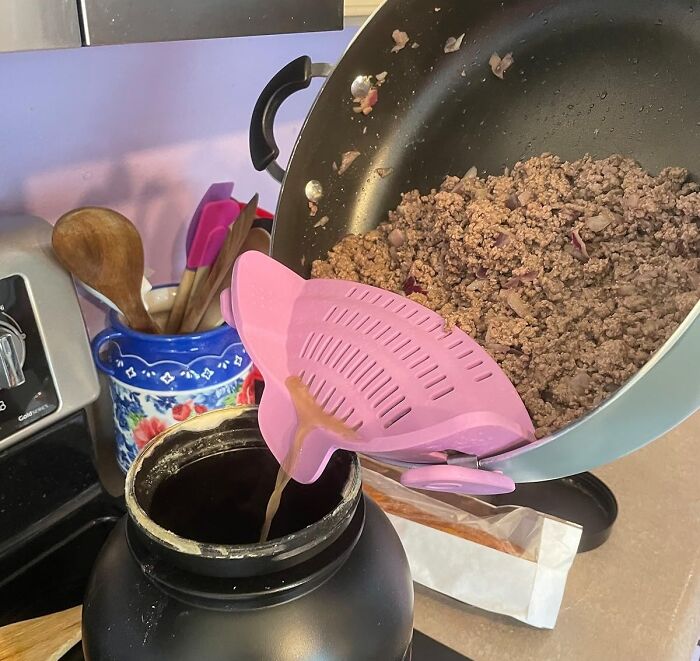 Pink strainer funnel pouring cooked ground meat into container, showing one of the most-wished-for Amazon finds.